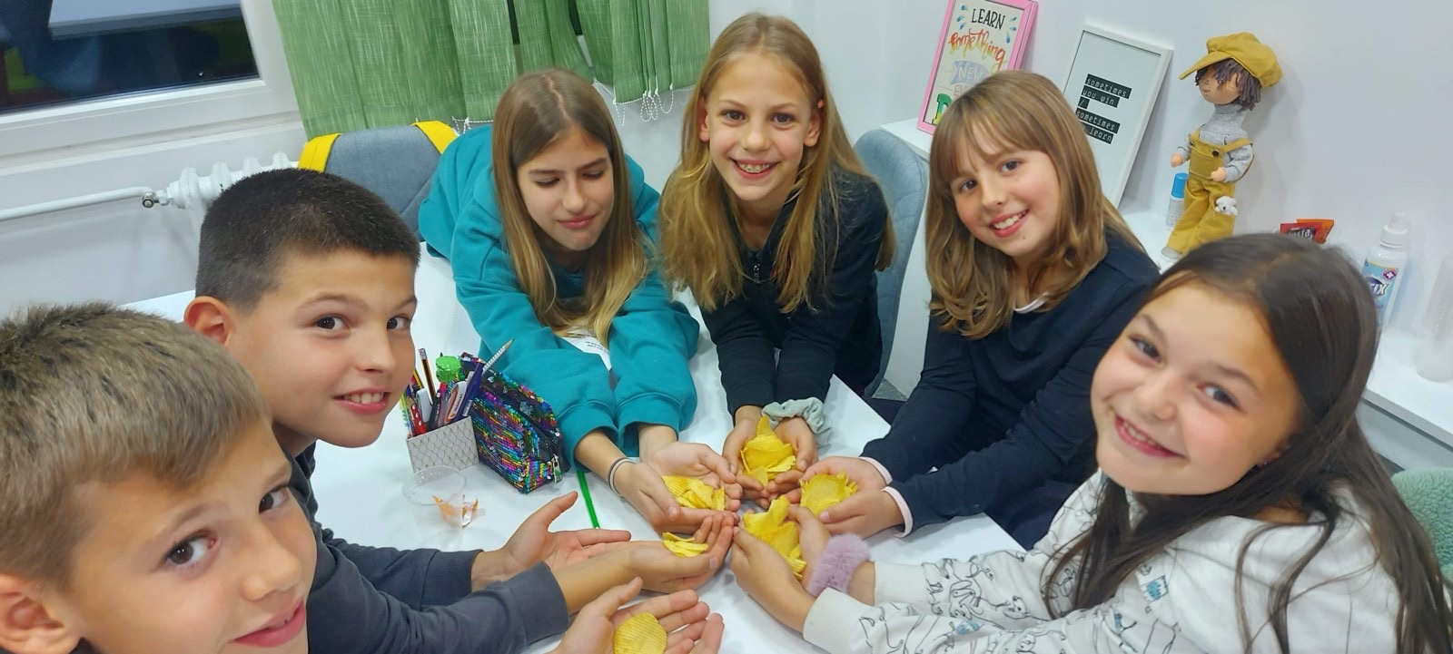 Grupa učenika na aktivnosti za stolom u Helenici